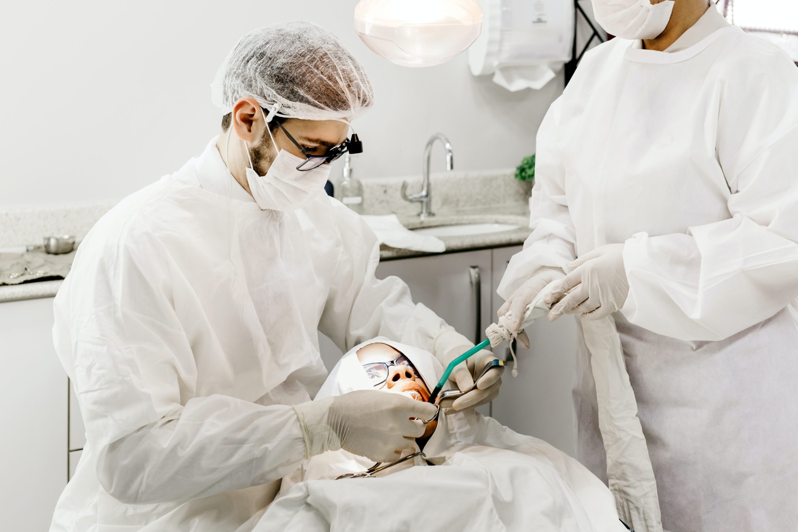 Dental hygienist looking at patients teeth