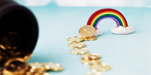 A rainbow with coins showcasing dental practice luck.