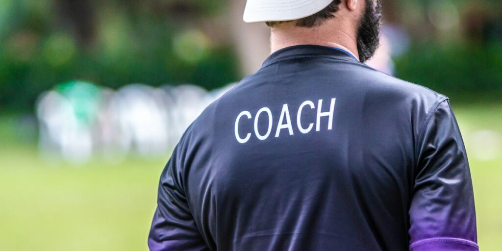 Consulting coach standing outside at a sports event