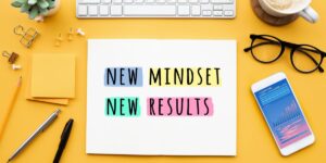 Computer and note that says new mindset new results